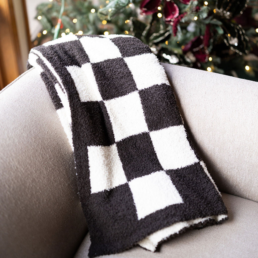 chocolate brown checkered cozy throw blanket on beige chair