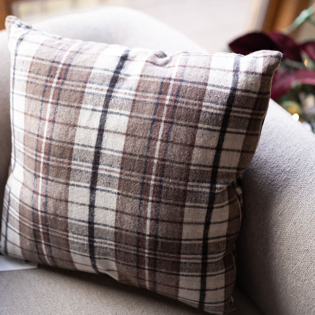 Brown plaid reversible pillow on chair